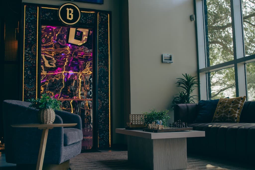 Bruder lounge seating with neon B alcove and board games
