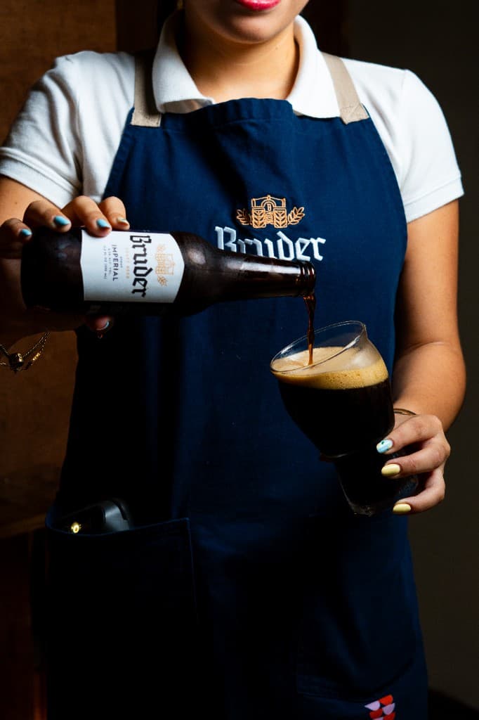 Pouring a Bruder Imperial Stout into a glass